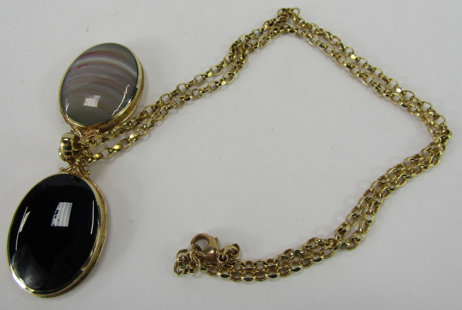 A Victorian semi precious stone set locket and chain, the oval locket set with black agate and strip - Image 3 of 3