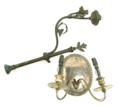 An Edwardian silver plated twin branch wall sconce, the circular back plate with part fluted decorat