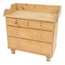 A Victorian pine chest, the top with a raised back and sides above two short and two long drawers, o