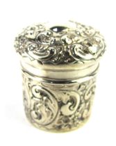 An Edward VII silver cylindrical toilet jar, with embossed foliate scroll decoration, maker A and J