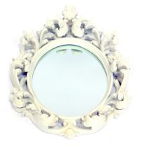 An elaborate 20thC wall mirror, the oval mirror in a painted white wooden frame, wire hanging back,