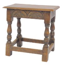 An early 20thC oak joint stool in Charles I style, the rectangular top with a moulded edge above car