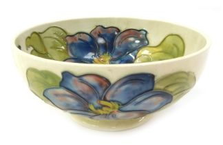 A Moorcroft pottery Clematis pattern bowl, impressed marks and paper label verso, 16cm diameter.