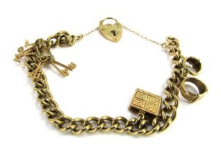 A 9ct gold charm bracelet, the curb link bracelet with safety chain and heart shaped padlock, charms