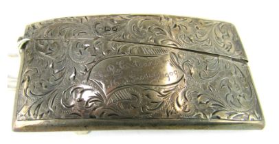 An Edward VII silver card case, of curved form with foliate scroll decoration, with banner reserve,