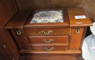 A wooden jewellery box.