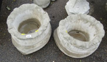 Two reconstituted stone sack planters, 25cm high, 41cm wide.