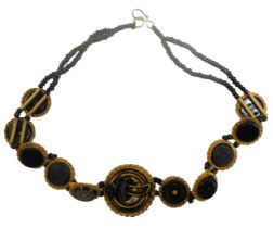 A Victorian memorial necklace, set with jet circular links, with gilt borders and two row beaded cha