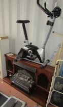 Assorted furniture, fire surround and an exercise bike. (2)