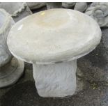 A reconstituted stone saddle stone, the circular top on a moulded base, 42cm high, 47cm wide.