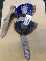 Two NFU (National Farmers Union) enamelled metal arm bands, with leather straps.