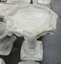 A reconstituted stone birdbath, in the Gothic style, on square foot, 66cm high, 51cm wide.