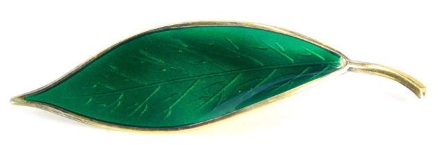 A 1950's David Andersen silver-gilt and enamel leaf brooch, set with dark green enamel, on silver-gi