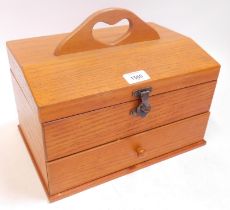 A light oak jewellery box, with lift top and drawer.