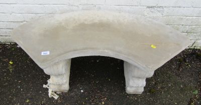 A reconstituted stone bench, on scroll supports with curved top, 42cm high, 85cm wide.