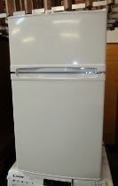 A white under counter fridge freezer.