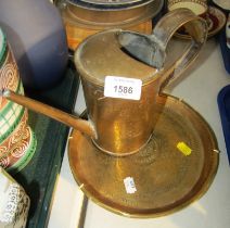 A 19thC brass oil can and a small charger. (2)