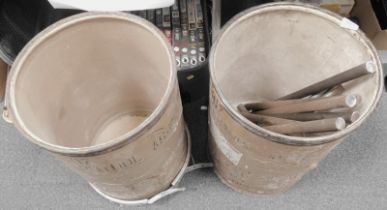 Two barrels, one containing various metal rods.