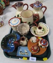 A small collection of Torquay Motto ware, to include two lidded jugs, mug, three piece cruet, etc. (