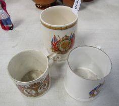 Two George VI Coronation mugs, and a George V Silver Jubilee beaker. (3)