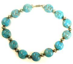 A Murano glass beaded necklace, each circular bead with blue twist and copper dotted decoration, on