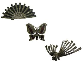 Three marquasite brooches, comprising an Art Deco style marquasite and onyx rising sun brooch, white