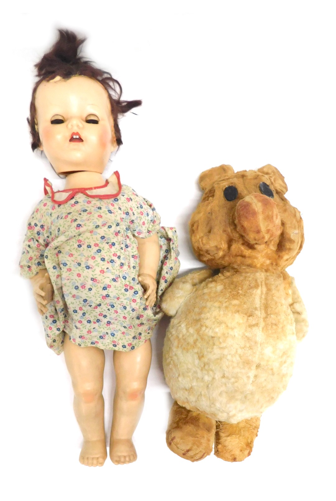 A Primo 1960s Teddy bear, 42cm high, and a Pedigree doll, in floral dress, 52cm high. (2)