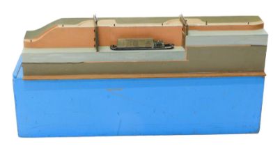 A museum model of a canal lock, 94cm wide, 21cm high, in blue ply travel case.