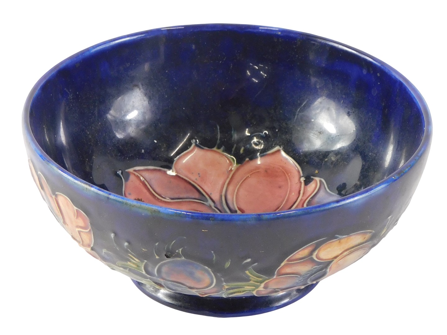 A Moorcroft Anemone pattern bowl, on a glazed blue ground with pink flowers, stamped to underside, 1