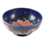 A Moorcroft Anemone pattern bowl, on a glazed blue ground with pink flowers, stamped to underside, 1