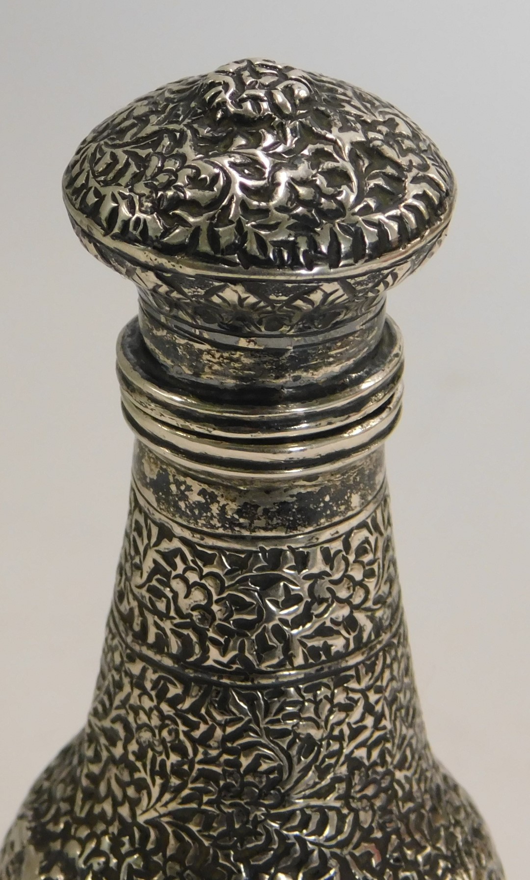 An Eastern white metal scent bottle, of hammered floral design, unmarked, 12cm high, 2.95oz. - Image 2 of 2