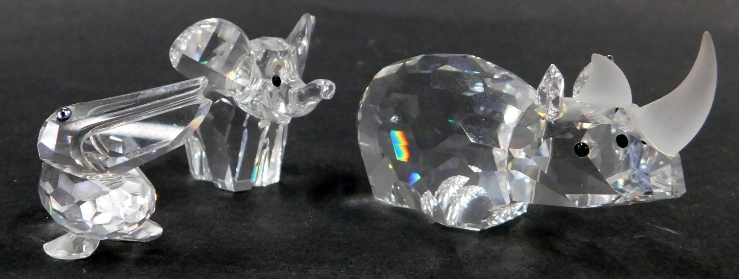 Three Swarovski crystal African animals, comprising a rhinoceros 3cm high, pelican 2.5cm high, and a