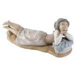 A Nao figure group of a child leaning on laundry basket, on stylised base, 28cm wide.