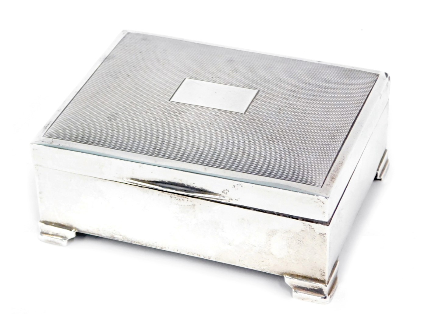 A George VI silver cigarette box, with engine engraved decoration, and a square vacant cartouche, on