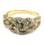 A 9ct gold and CZ set dress ring, of layered cross over design, set with tiny CZs on a yellow metal