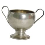 A white metal trophy cup, with two arched handles, on a stepped and ribbed foot, white metal stamped