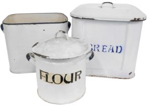 Three 20thC enamel bins, comprising a bread bin on white ground with blue border, 30cm diameter, and