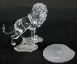 A Swarovski crystal figure group of a roaring lion, on rocked perch, 13cm high, boxed with certifica