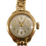 An Avia 9ct gold ladies wristwatch, the small silvered dial 1.5cm diameter, on a fancy link bracelet