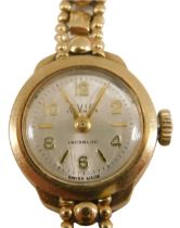 An Avia 9ct gold ladies wristwatch, the small silvered dial 1.5cm diameter, on a fancy link bracelet