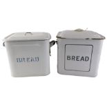 Two 1930s enamel bread bins, each on white enamel with blue rim and lids, 30cm high. (2)