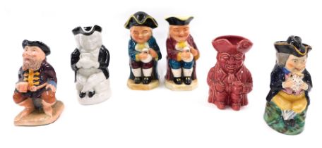 An unusual monochrome Staffordshire Toby jug, another brightly coloured Toby jug with hat, and other