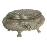 An Eastern silver plated jewellery casket, of shaped oval form with raised scroll decoration, with f