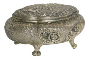 An Eastern silver plated jewellery casket, of shaped oval form with raised scroll decoration, with f