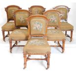 A set of fourteen Victorian elm and burr elm dining chairs, each with an arched gadrooned back with