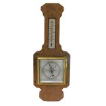 An Art Deco walnut and rosewood aneroid barometer with thermometer, 41cm high.