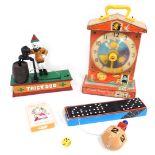 A novelty trick dog money box, 18cm high, 19cm wide, a Fisher Price music box teaching clock, cased