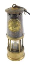 A Protector Lamp and Lighting Company mining lamp, numbered 87, bearing crest in carry hook, convert