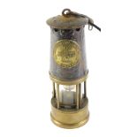 A Protector Lamp and Lighting Company mining lamp, numbered 87, bearing crest in carry hook, convert