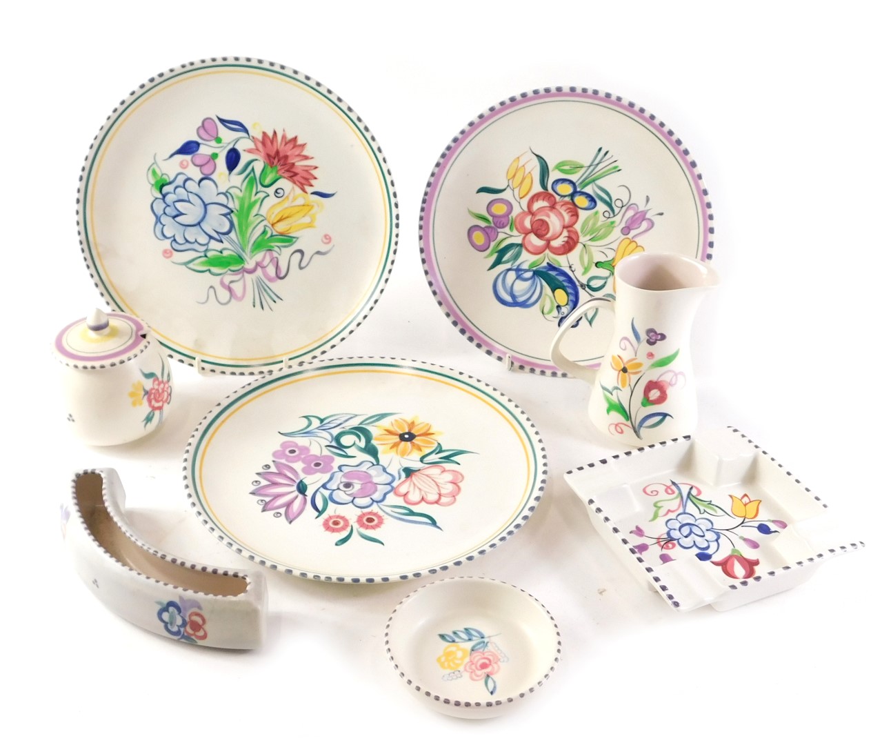 A group of Poole pottery, comprising two large plates, a medium plate, ashtray, mustard and cover, j